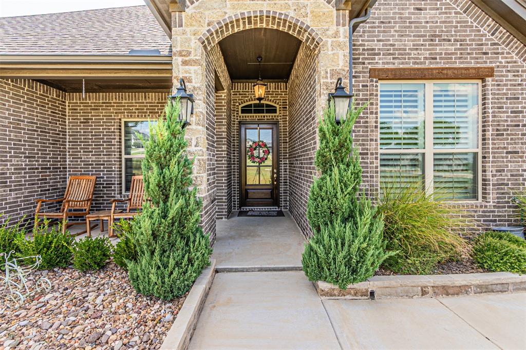 1009 Henry Way Springtown, TX 76082 - Photo 5 of 40 View of exterior entry with brick siding