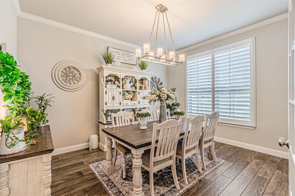 1009 Henry Way Springtown, TX 76082 - Photo 7 of 40 Dining space with crown molding and dark wood-type flooring
