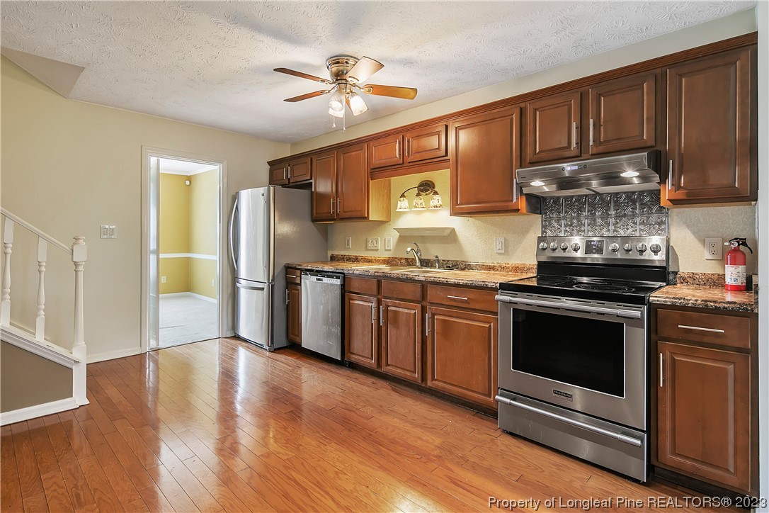 6875 Baystone Road Fayetteville, NC 28314 - Photo 18 of 50 a kitchen with granite countertop stainless steel appliances and wooden cabinets