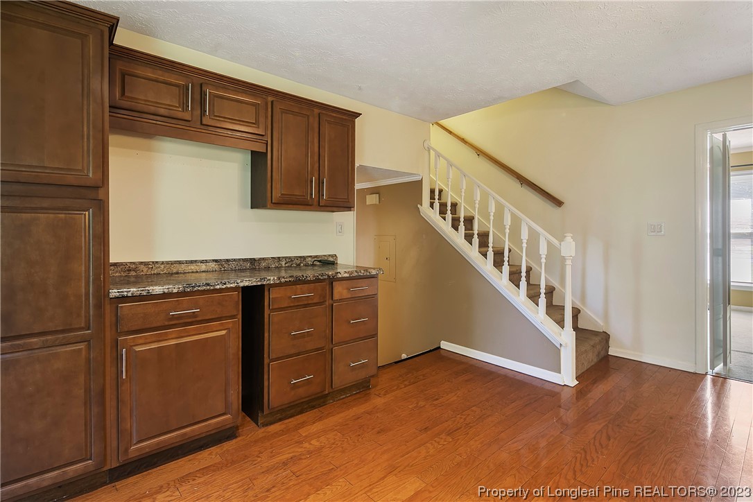 6875 Baystone Road Fayetteville, NC 28314 - Photo 20 of 50 a view of a kitchen with cabinets and wooden floor