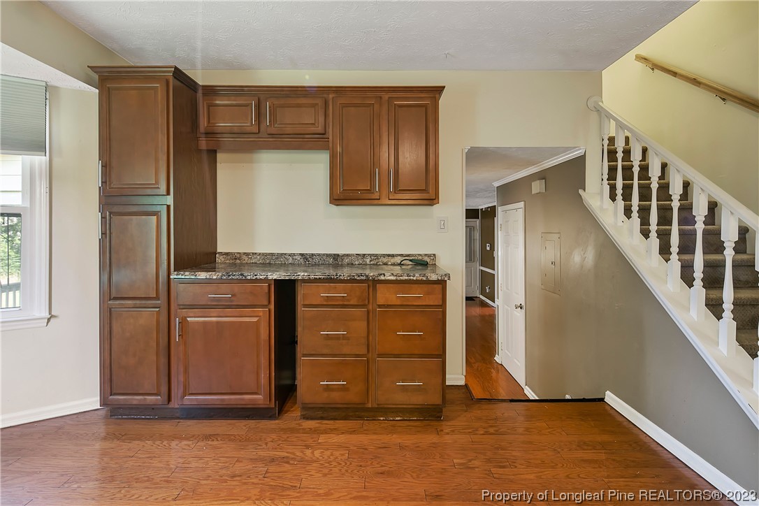 6875 Baystone Road Fayetteville, NC 28314 - Photo 21 of 50 a kitchen with granite countertop a refrigerator and cabinets