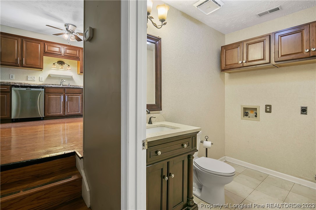 6875 Baystone Road Fayetteville, NC 28314 - Photo 22 of 50 a bathroom with a granite countertop toilet sink and mirror