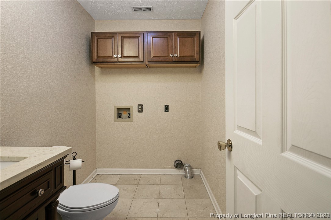 6875 Baystone Road Fayetteville, NC 28314 - Photo 23 of 50 a bathroom with a granite countertop toilet and a sink
