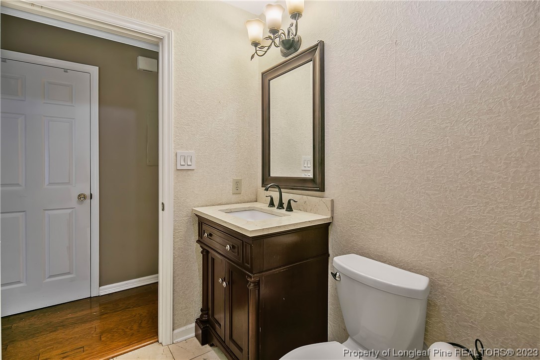 6875 Baystone Road Fayetteville, NC 28314 - Photo 24 of 50 a bathroom with a granite countertop toilet sink and mirror