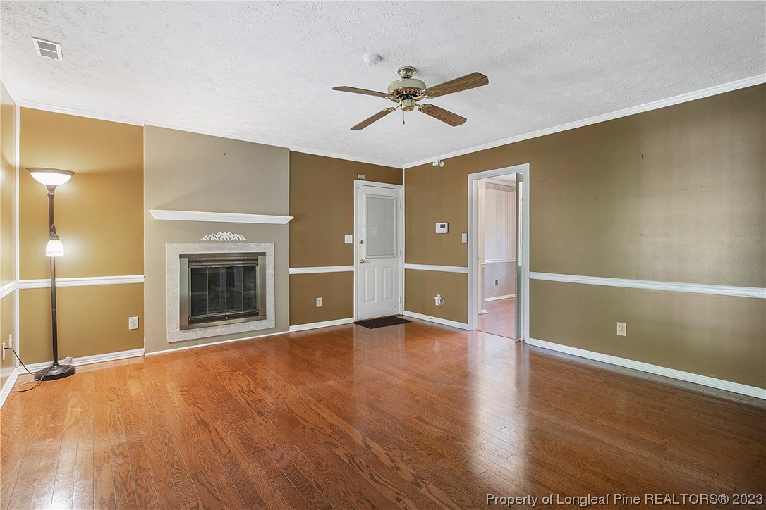 6875 Baystone Road Fayetteville, NC 28314 - Photo 26 of 50 a view of an empty room with a fireplace and a window