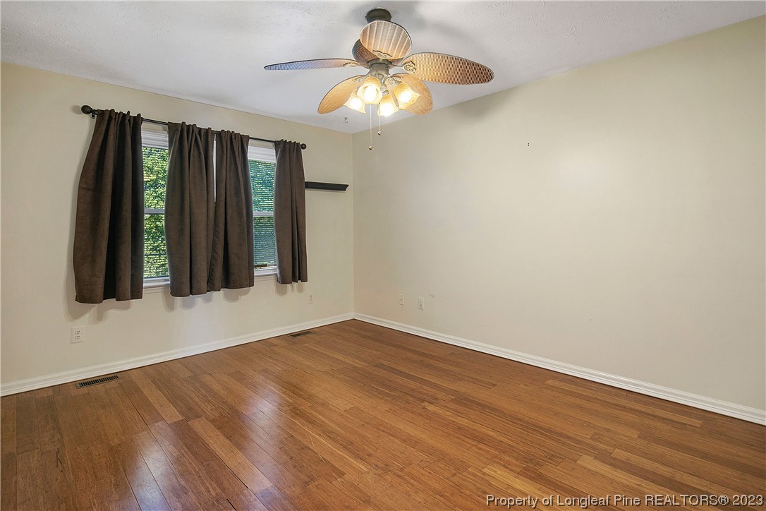 6875 Baystone Road Fayetteville, NC 28314 - Photo 29 of 50 a view of an empty room with wooden floor and a window