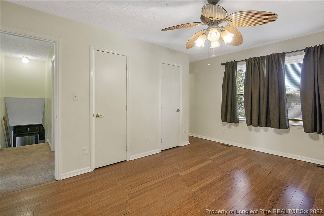 6875 Baystone Road Fayetteville, NC 28314 - Photo 32 of 50 a view of an empty room with window and wooden floor