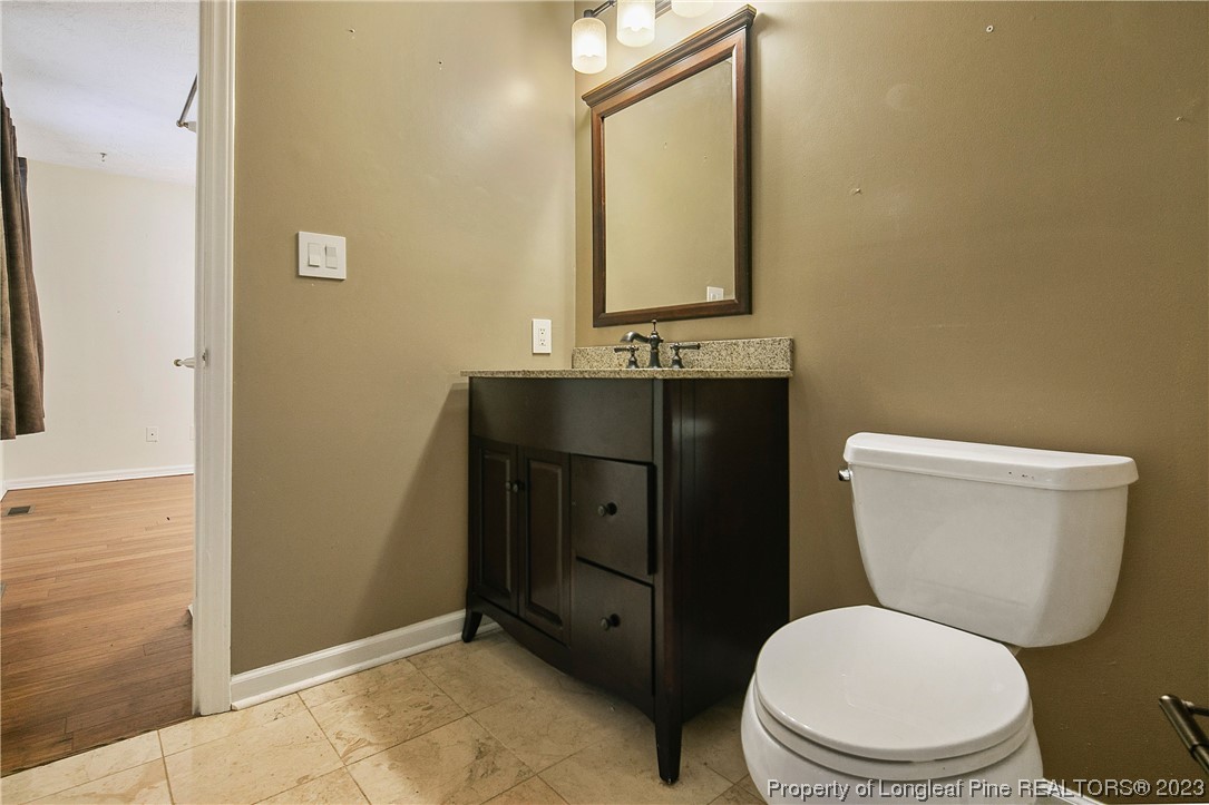6875 Baystone Road Fayetteville, NC 28314 - Photo 34 of 50 a bathroom with a toilet a sink and mirror