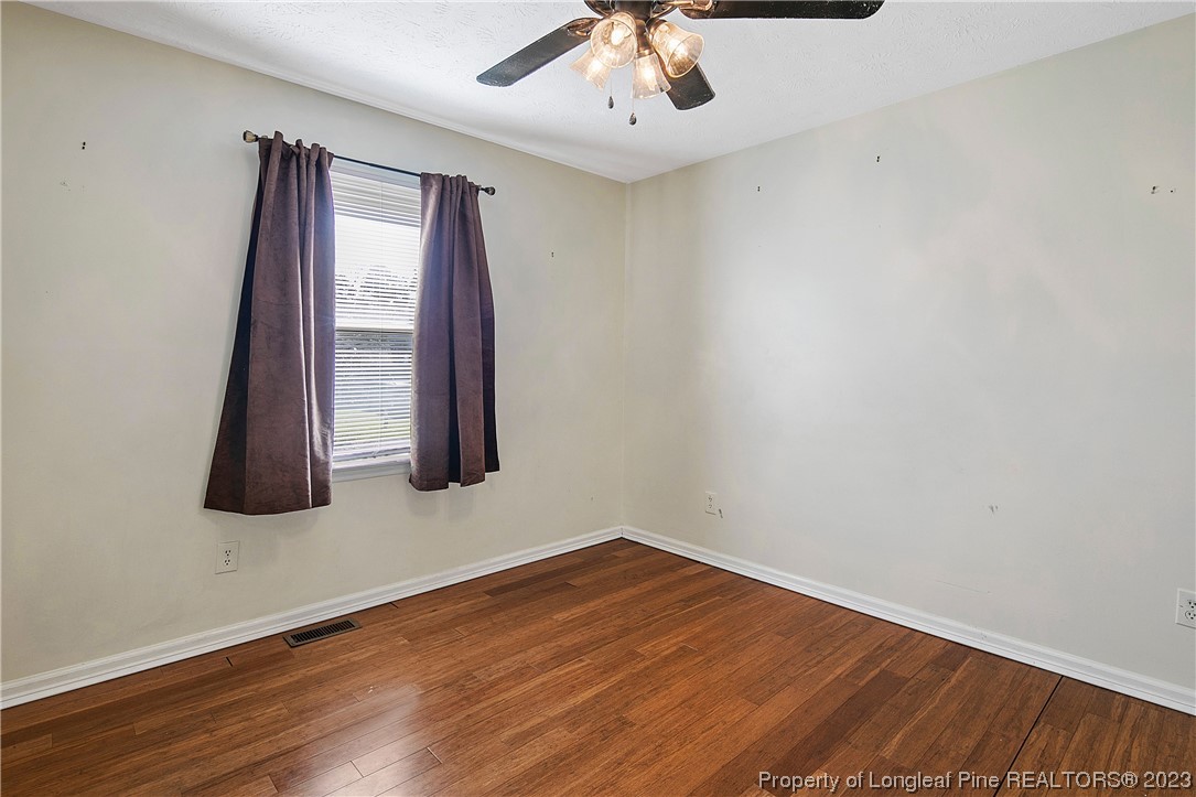 6875 Baystone Road Fayetteville, NC 28314 - Photo 35 of 50 an empty room with wooden floor and entryway