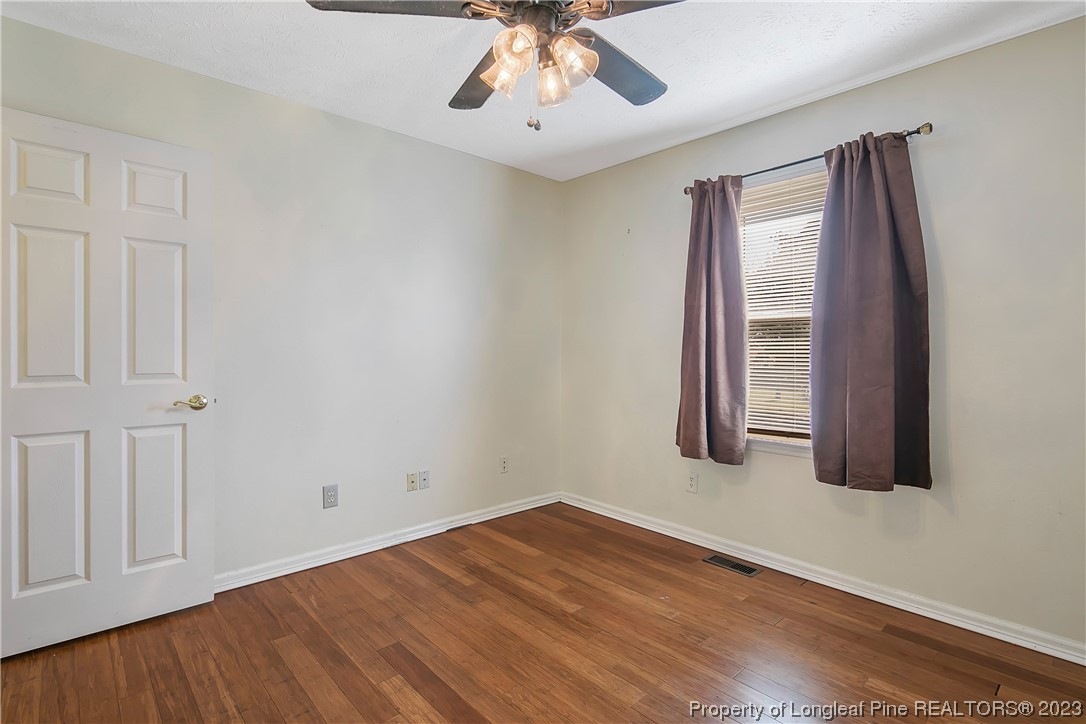 6875 Baystone Road Fayetteville, NC 28314 - Photo 38 of 50 wooden floor in an empty room with a window