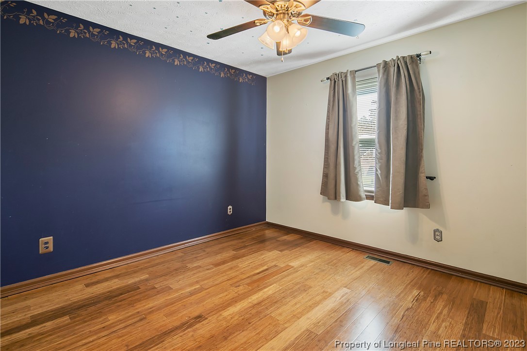 6875 Baystone Road Fayetteville, NC 28314 - Photo 41 of 50 an empty room with wooden floor and windows