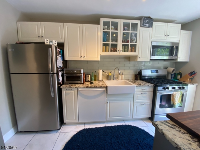 390 Morris Avenue, Unit 4 Summit, NJ 07901 - Photo 2 of 11 a kitchen with a refrigerator stove and sink