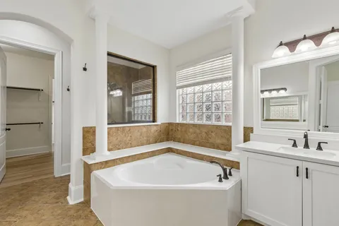 a bath tub sitting next to a bathroom sink