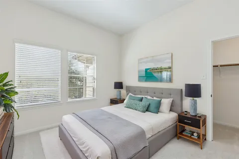 a bedroom with a bed and glass windows