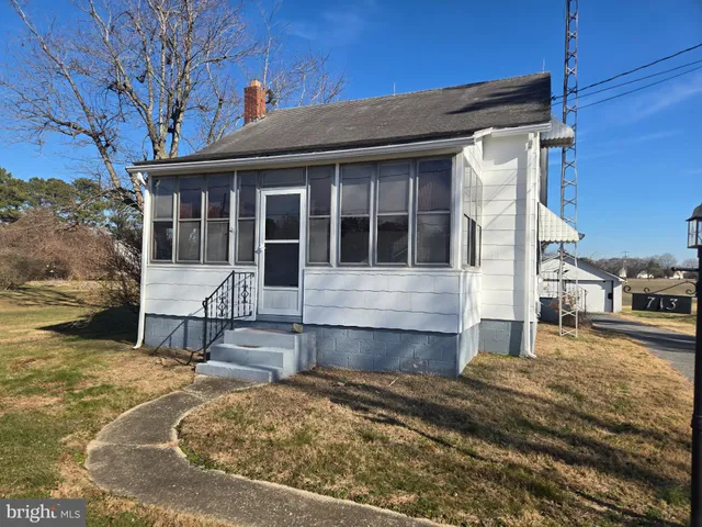 a front view of a house with a yard patio and fire pit