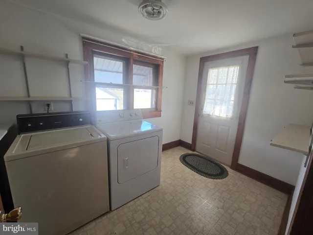 a view of storage and utility room with washer and dryer