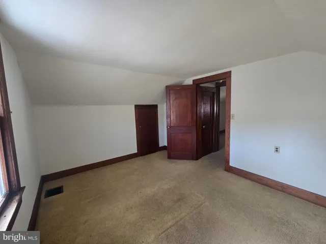 an empty room with closet area