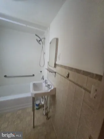a bathroom with a sink a toilet and bathtub