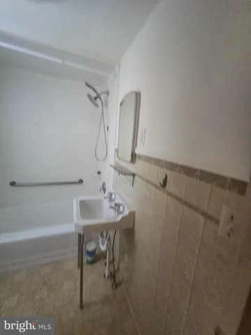 a bathroom with a sink a toilet and bathtub