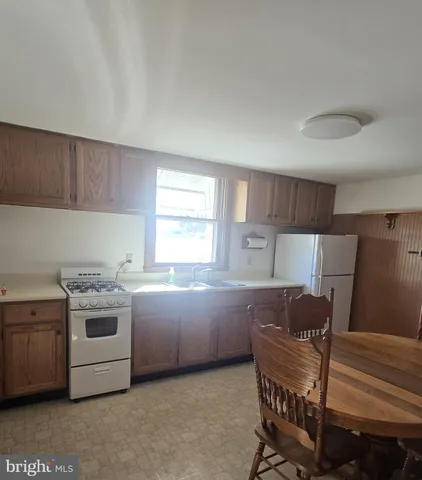 a kitchen with stainless steel appliances a stove a sink and a refrigerator