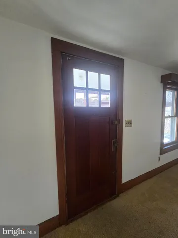 an empty room with a empty space and windows