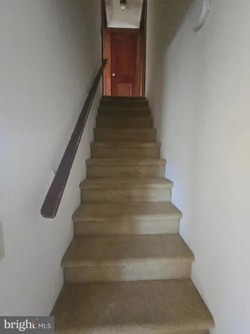 a kitchen with a sink a stove cabinets and a window