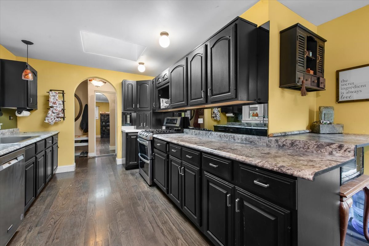 26 Glen Echo Road Elgin, IL 60120 - Photo 5 of 34 a kitchen with stainless steel appliances granite countertop wooden cabinets a stove top oven a sink and dishwasher