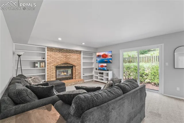 a living room with furniture and a fireplace