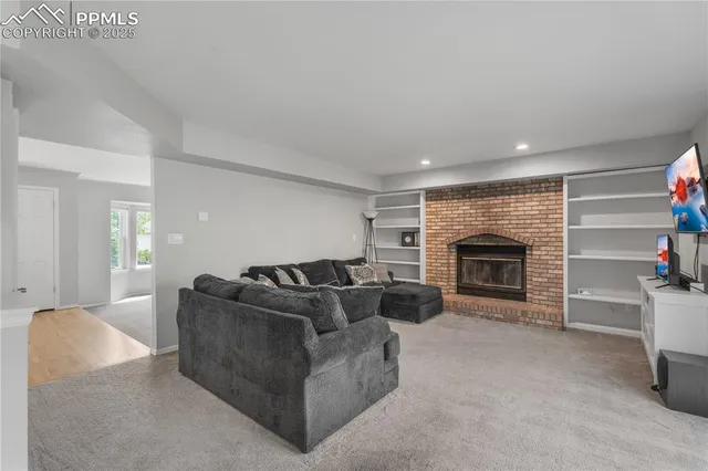 a living room with furniture and a fireplace