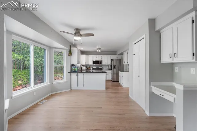 a view of kitchen with stainless steel appliances refrigerator oven and cabinets