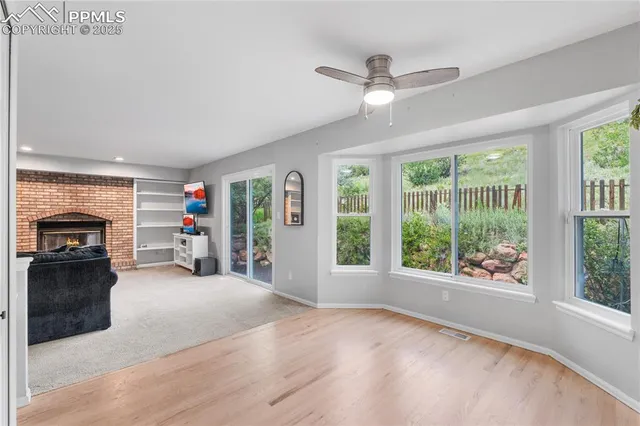 a view of a livingroom with furniture staircase and windows