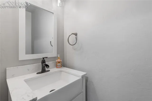 a bathroom with a sink and vanity