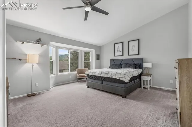 a spacious bedroom with a bed and a large window