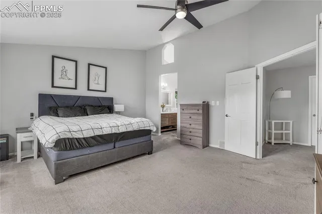 a spacious bedroom with a bed and a view of living room