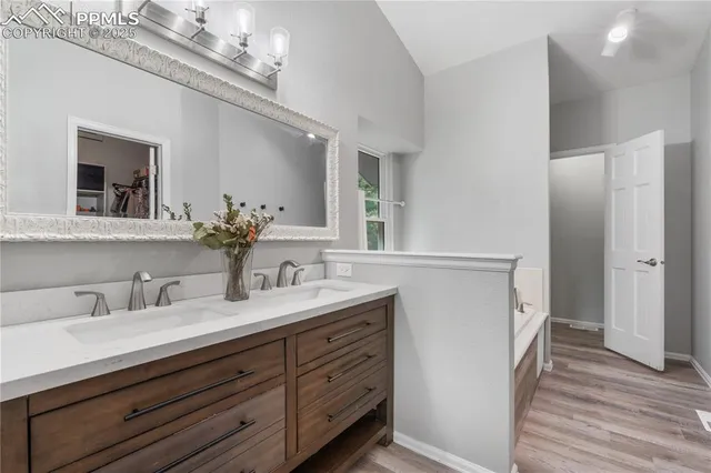 a bathroom with a double vanity sink and a mirror