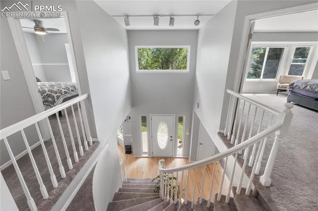 a view of entryway and hall with wooden floor