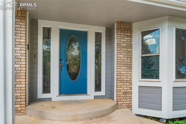 a front view of a house with large windows