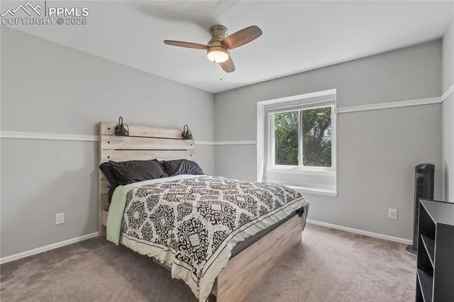 a bedroom with a bed and a ceiling fan