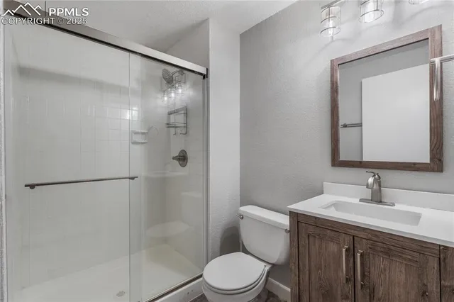 a bathroom with a sink vanity mirror and toilet