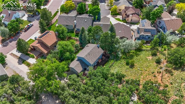 an aerial view of multiple houses with yard