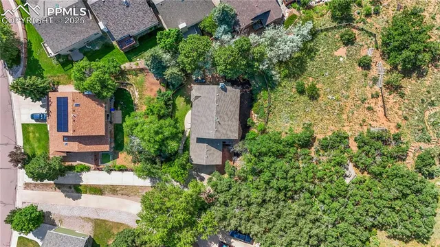 an aerial view of a house with a yard and lake view