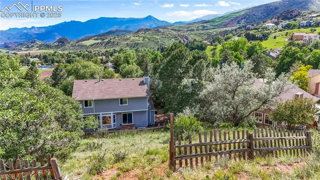 a view of a house with a yard from a balcony