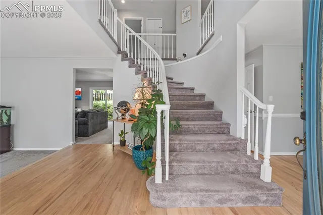 a view of entryway and hall with wooden floor