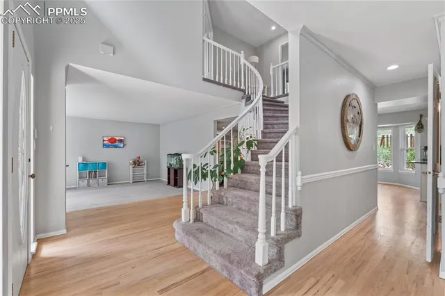 a view of entryway livingroom and hall with wooden floor