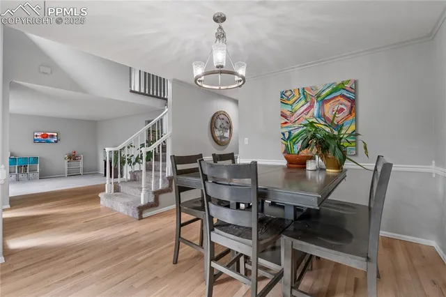 a view of a dining room with furniture wooden floor and a chandelier