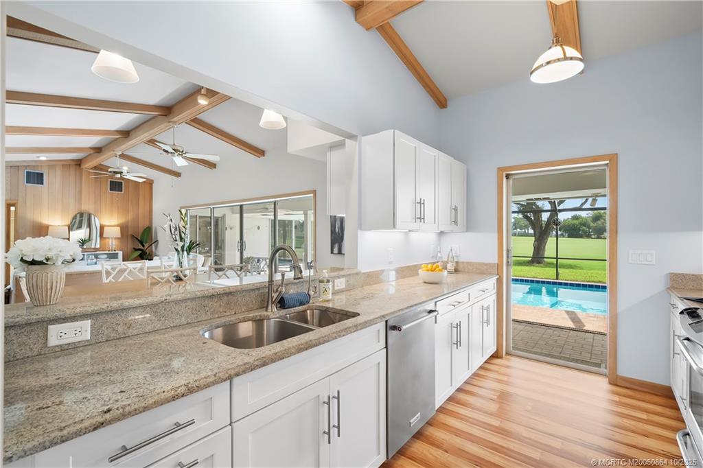 3453 Southeast Fairway East Stuart, FL 34997 - Photo 14 of 43 a kitchen with a sink and a large window