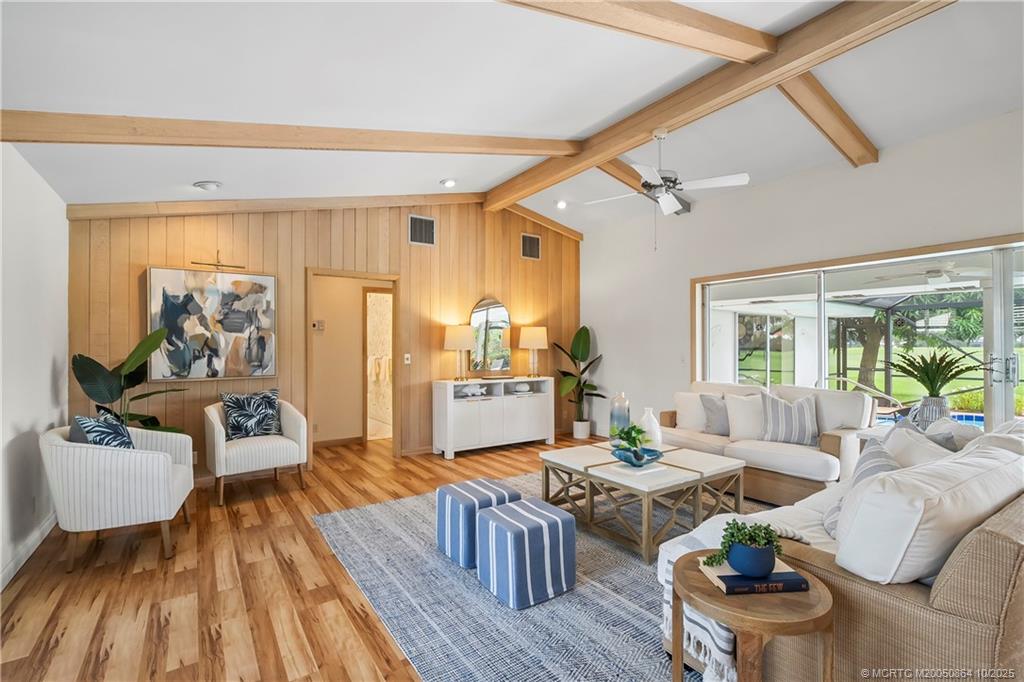 3453 Southeast Fairway East Stuart, FL 34997 - Photo 24 of 43 a living room with furniture and a wooden floor