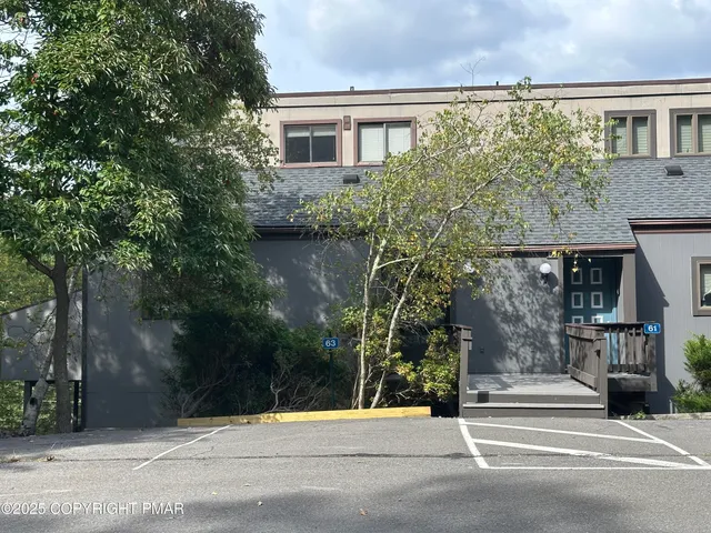 a view of a house with a garden and pathway