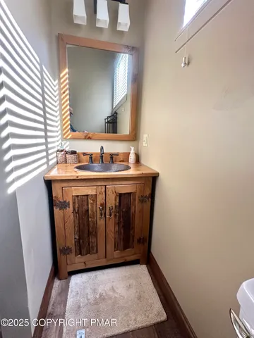 a bathroom with a sink a toilet and mirror