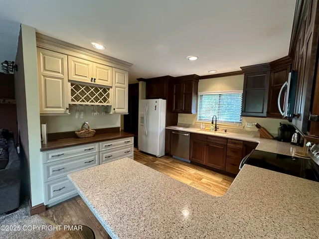 a kitchen with stainless steel appliances granite countertop a sink stove and refrigerator